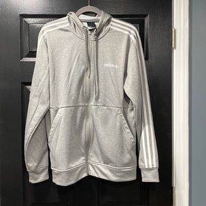 Woman’s size medium, Adidas zip up hoodie with front pockets. Grey and white